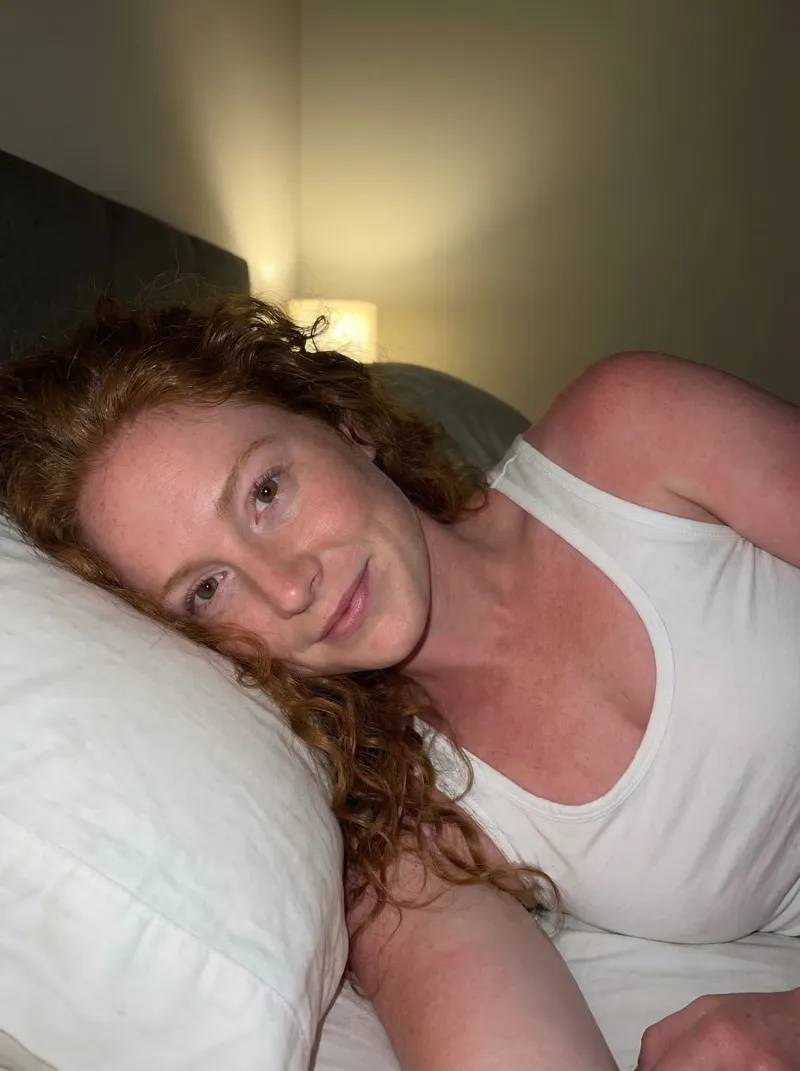 The generated look — same character, now in a casual bedroom setting with warm lamplight and natural framing